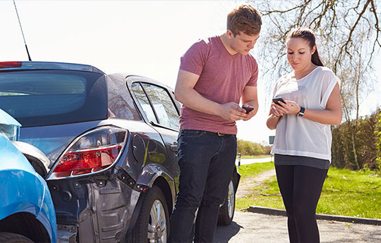 Man and woman exchanging info following an auto collision in San Rafael