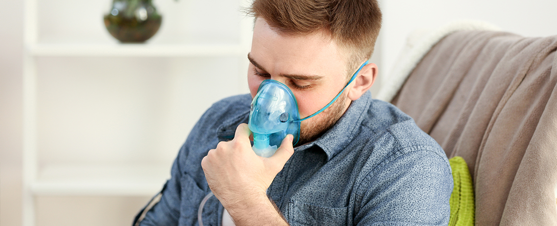 Man using nebulizer for asthma control