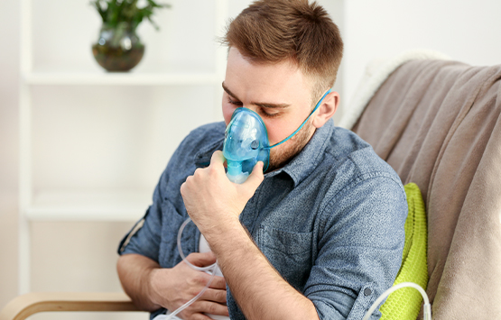 Man with asthma using inhalator