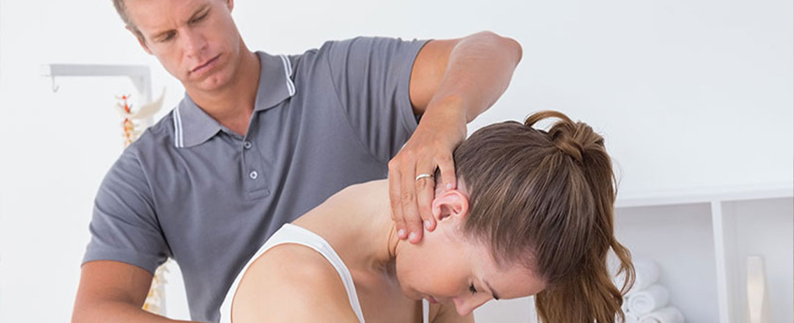 Chiroprator at Neck, Back, Arm, Leg and Headache Pain Relief Clinic of Marin in San Rafael adjusting female patient's neck to relieve whiplash effects