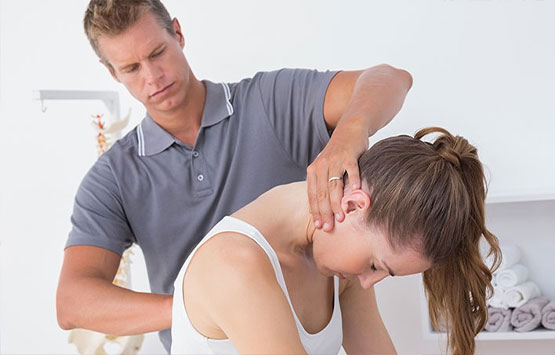 Chiroprator at Neck, Back, Arm, Leg and Headache Pain Relief Clinic of Marin in San Rafael adjusting female patient's neck to relieve whiplash effects