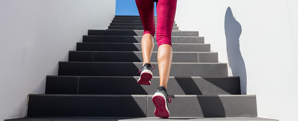 Woman running up stairs for cardio workout