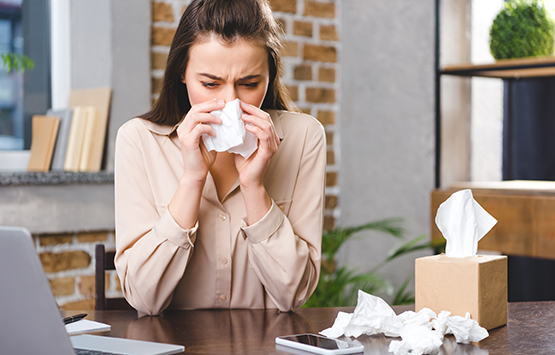 Woman with allergies researching chiropractic care for allergy relief