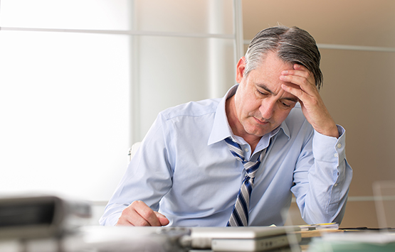 Man stressed at work in need of chiropractic care for stress relief