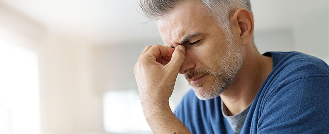 Man suffering with severe migraine