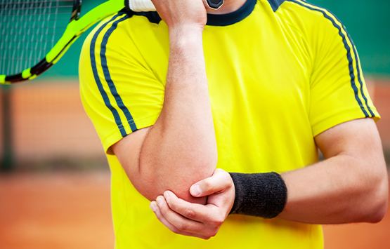 tennis player in pain from elbow injury