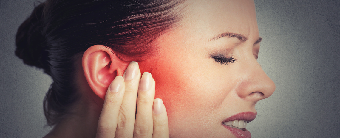 Woman suffering with inner ear pain