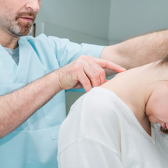 Patient receiving chiropractic consultation at Neck, Back, Arm, Leg and Headache Pain Relief Clinic of Marin in San Rafael