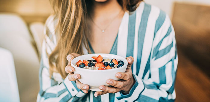 patient eating a healthy cereal after receiving diet guidance from San Rafael chiropractor