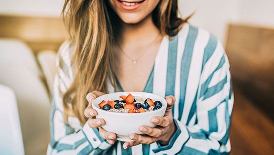 patient eating a healthy cereal after receiving diet guidance from San Rafael chiropractor