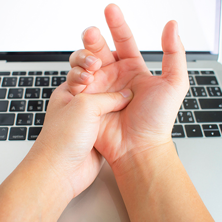 Person suffering with carpal tunnel pain in need of chiropractic care in San Rafael