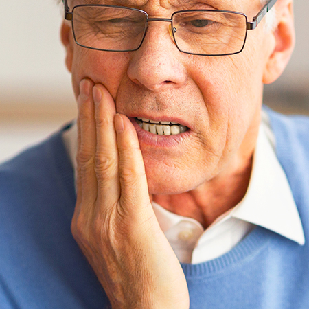 Man suffering with jaw pain in need of chiropractic care in San Rafael